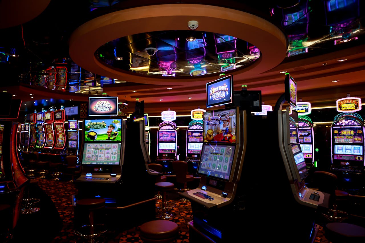 about-01 Vibrant casino floor with colorful slot machines and bright lights capturing a lively gaming atmosphere.