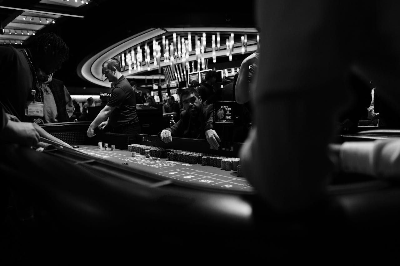 services-01 High-stakes gambling at a casino craps table in black and white.