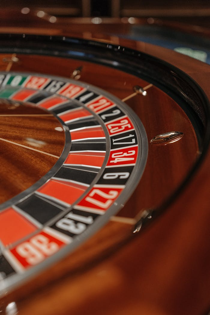 hero-img-01 Detailed close-up of a roulette wheel in a casino, focusing on numbers and colors.